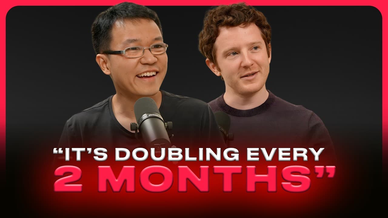 Scott Wu speaking into a microphone at a round table with Russell Kaplan and another individual.